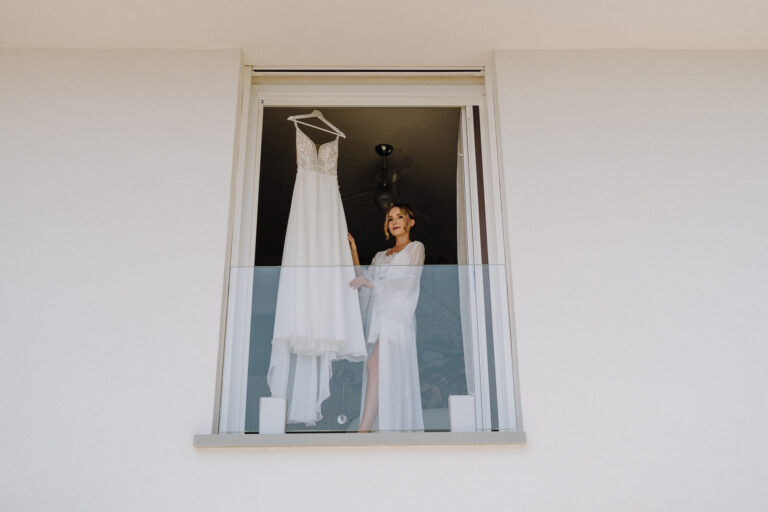 Bride in the window during getting ready, Lake Garda villa