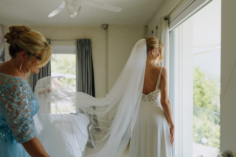 Bride in her dress by the window, Lake Garda villa