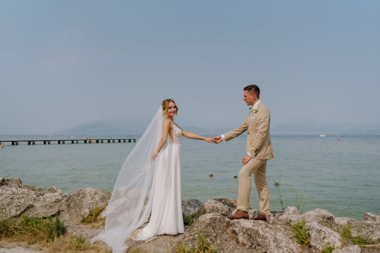 Bride and groom by the water on Lake Garda.