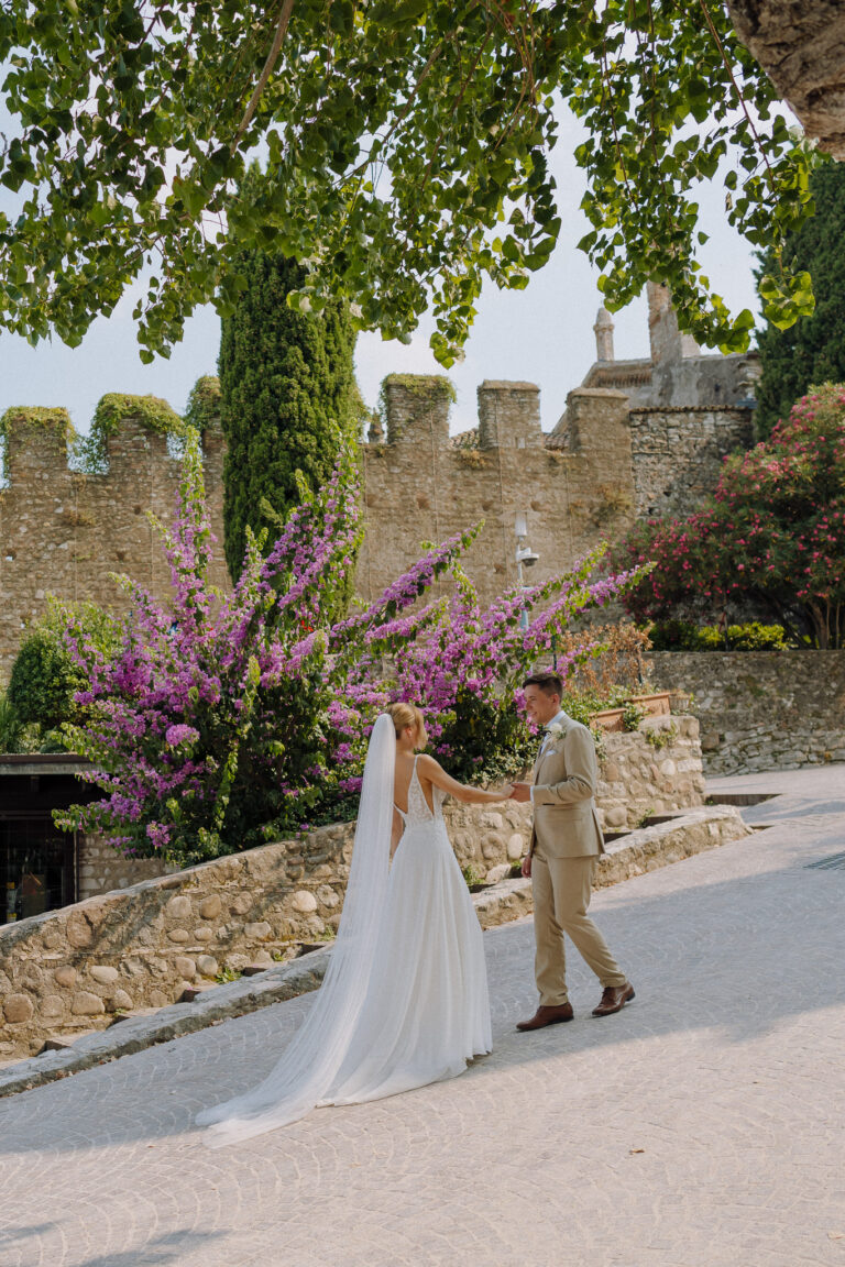 Bride and groom walking through Sirmione, Garda