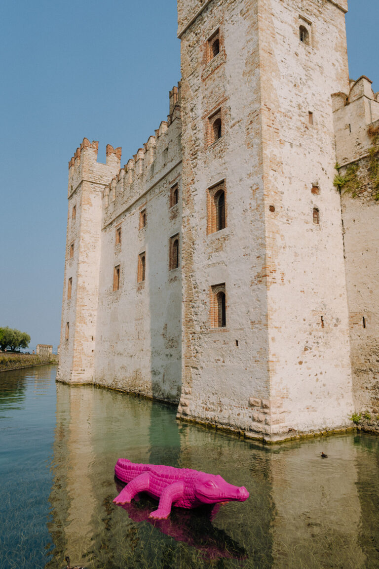 Castle detail in Sirmione on Lake Garda, pink crocodile.