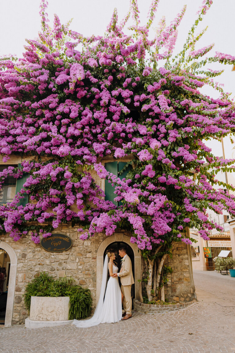 Couple portrait under pink flowers, Lake Garda wedding