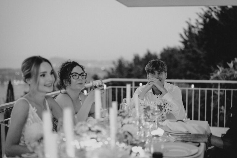 Dinner table scene with guests, intimate villa reception