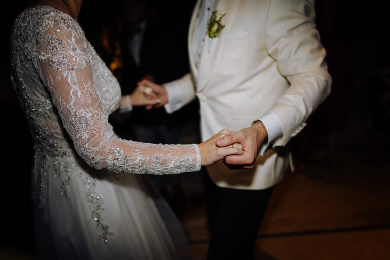 Hands and rings close-up during the reception, intimate detail in Rome.