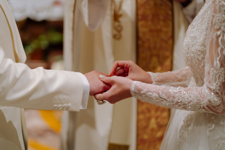 Close-up of hands during the ceremony, intimate wedding moment in Rome.