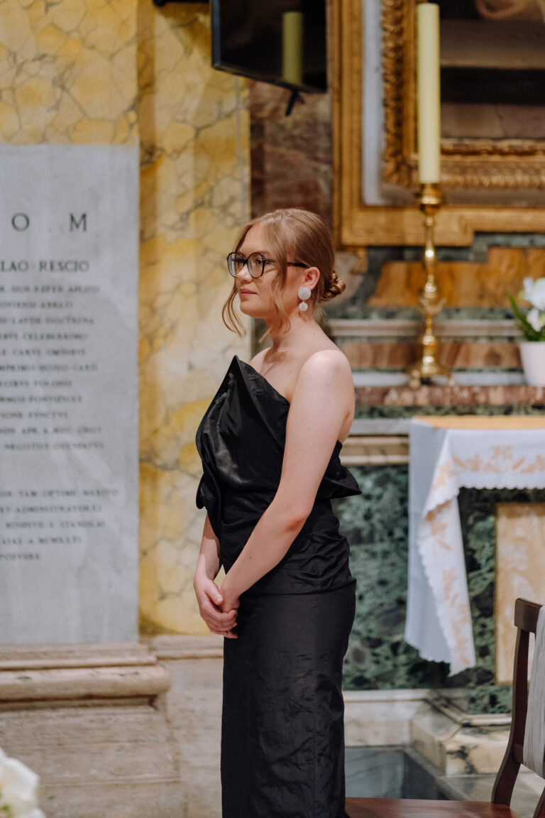 Wedding guest portrait inside the church in Rome, quiet candid moment