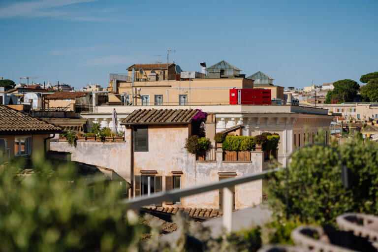 Rome rooftops and warm city textures, quiet in-between moment.