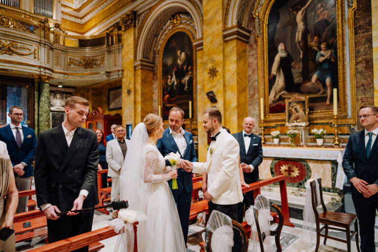 Bride and groom standing together during the church ceremony in Rome