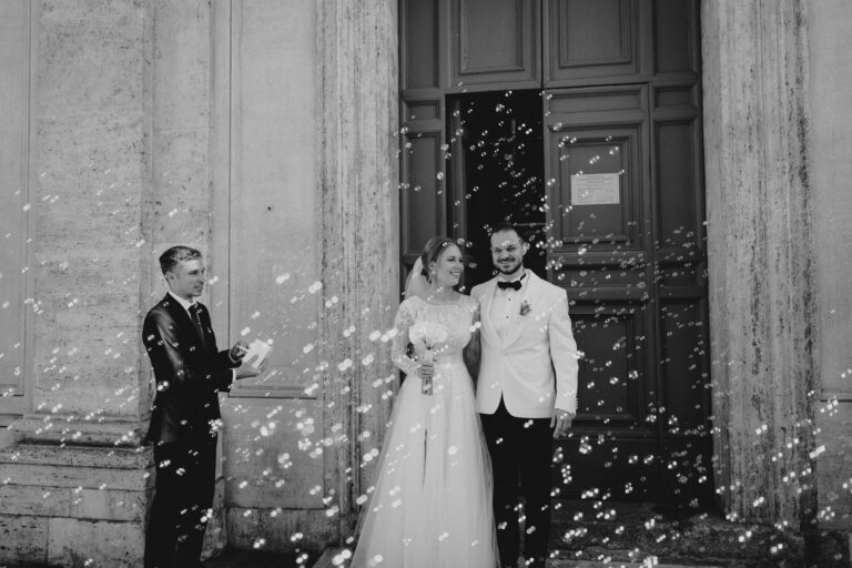 Newlyweds outside a church doorway in Rome, classic destination wedding photo