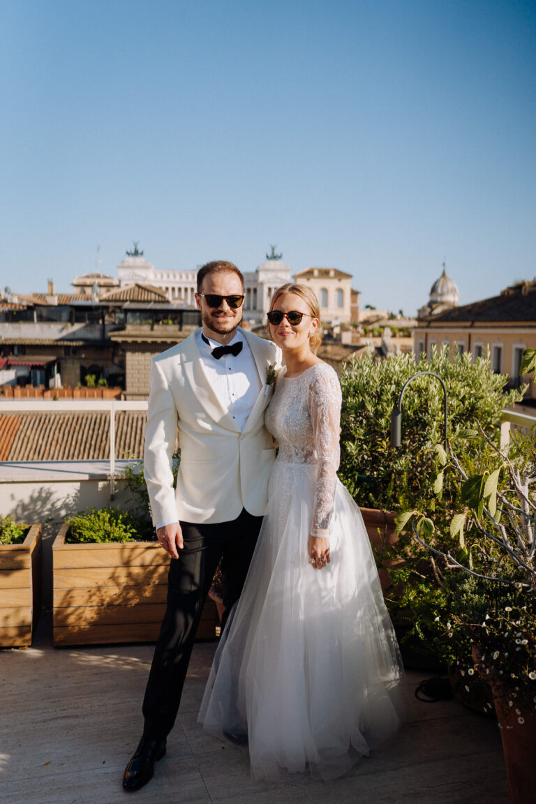 Bride and groom on a Rome terrace, relaxed portraits with the city behind.