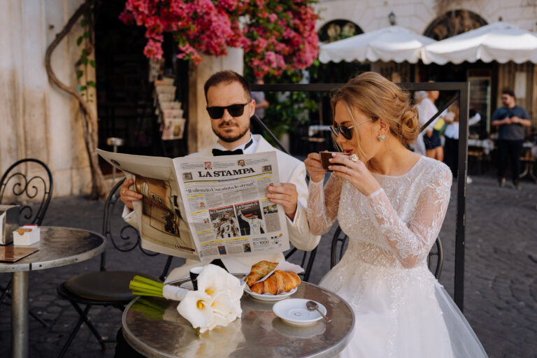 Couple at a café in Rome, reading a newspaper and sharing a quiet moment.
