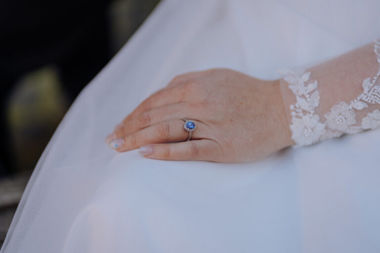 Close up of bride’s hand with engagement ring, fine art wedding detail.