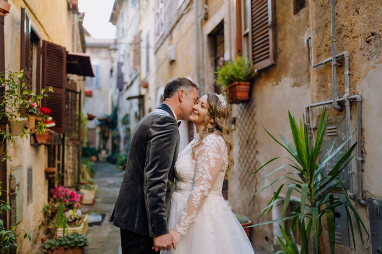 Bride and groom embracing in Tivoli, Italy, warm winter light.