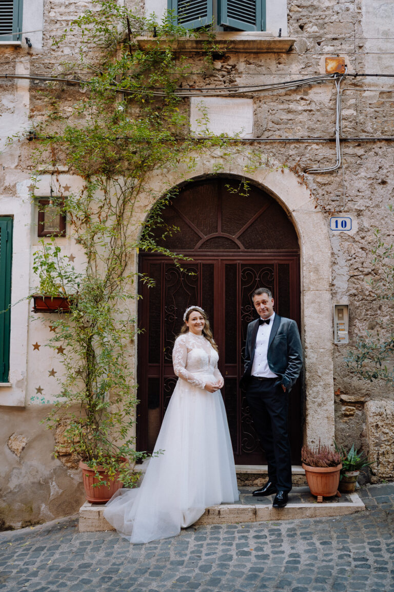 Couple portrait in front of an Italian doorway in Tivoli, elopement photography.