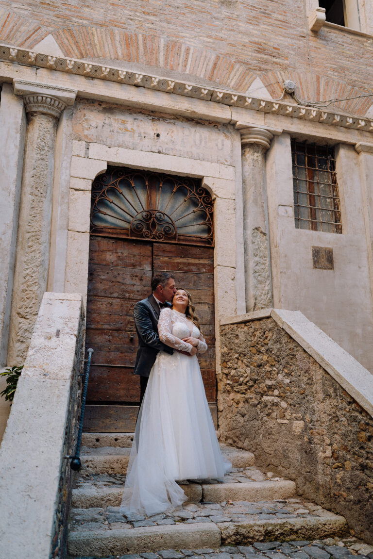 Bride standing in a historic Tivoli doorway, soft natural light.