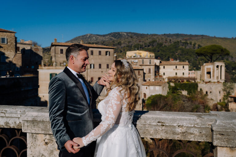 Bride and groom in Tivoli with historic Italian architecture in the background.