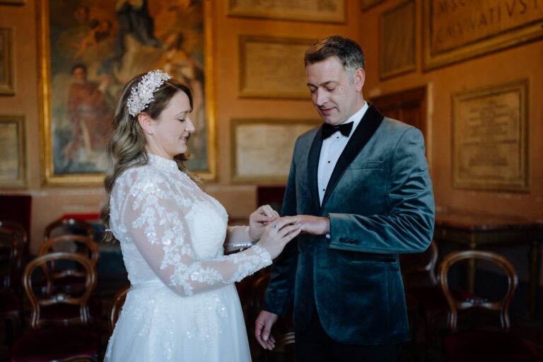 Ring exchange moment during a civil wedding ceremony in Tivoli, Italy.