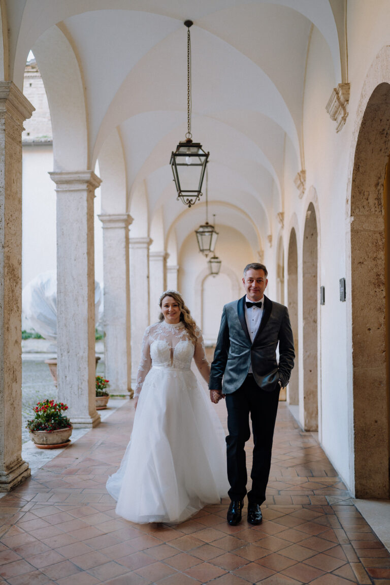 Couple portrait under arches in Tivoli, Italy, timeless black and white.