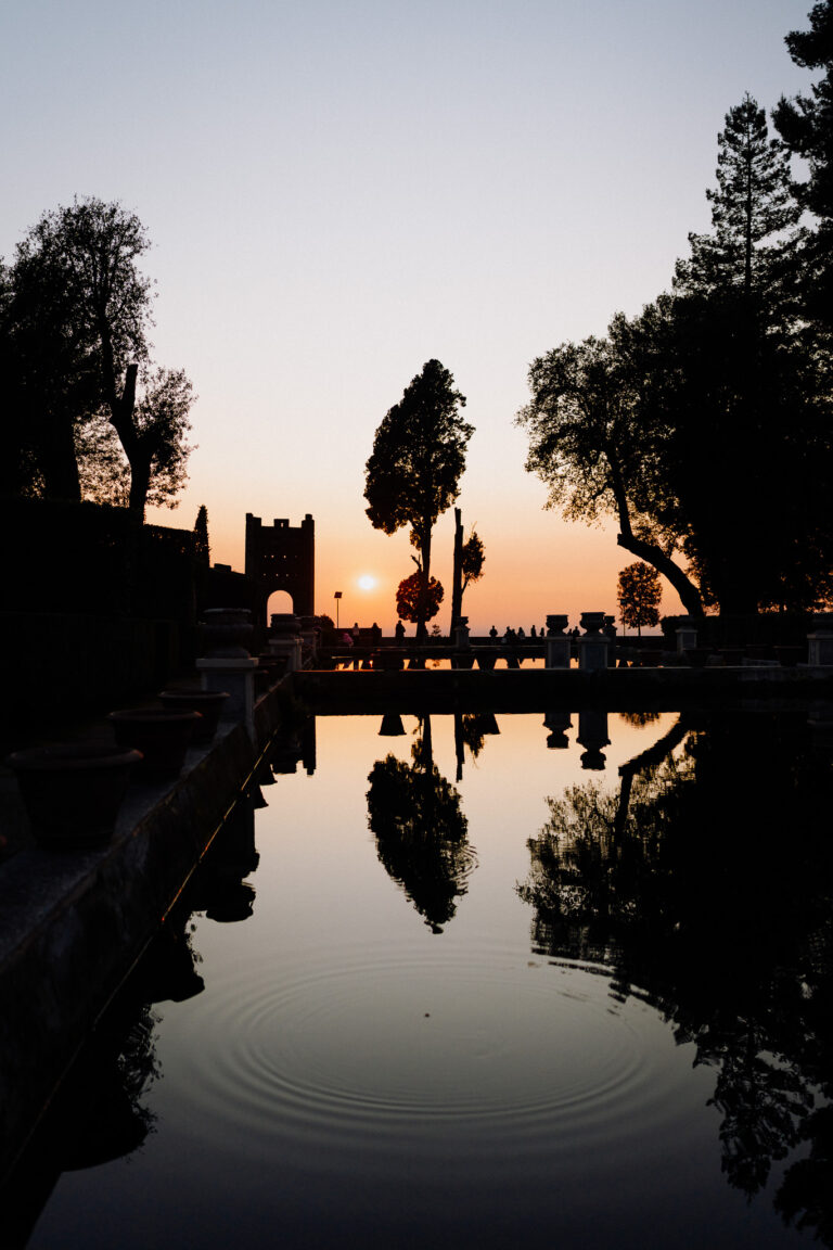 Sunset reflection scene at Villa d’Este in Tivoli, Italy, romantic atmosphere.