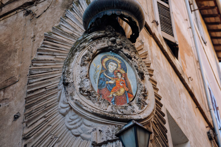 Detail of a Roman street shrine in Tivoli, Italy, atmospheric wedding story image