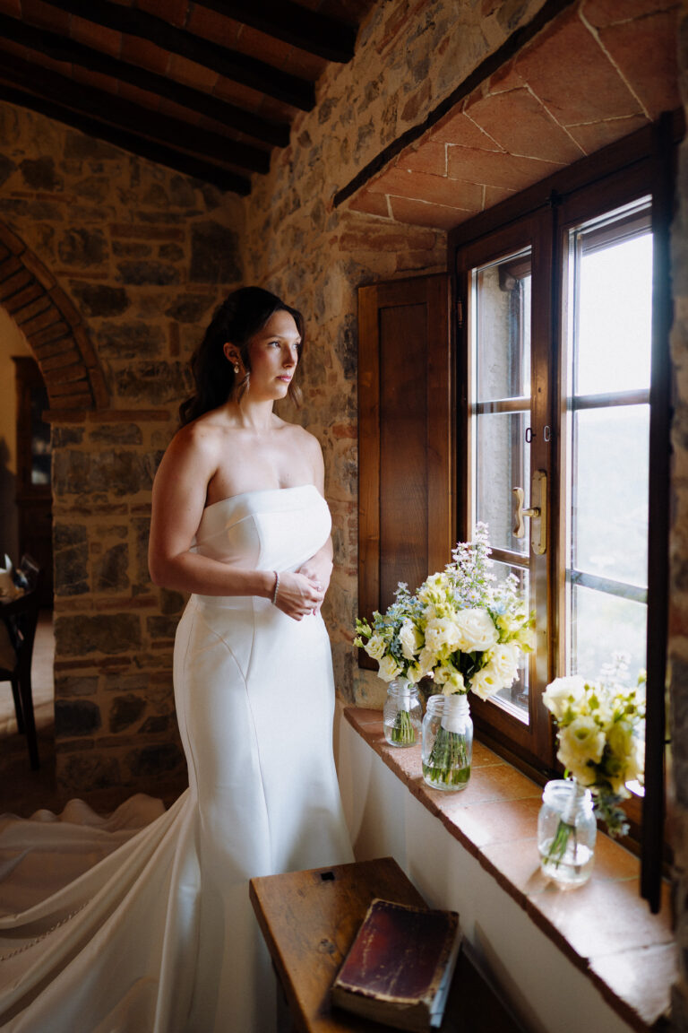 Bride portrait by a window in warm light, Tuscany.