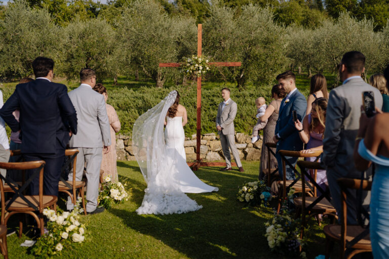 Bride walking to the ceremony outdoors at Podere Ferrale