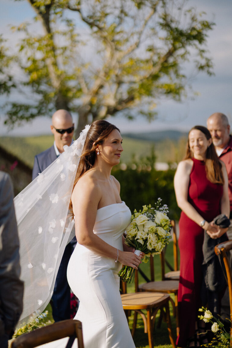 Bride walking to the ceremony outdoors at Podere Ferrale