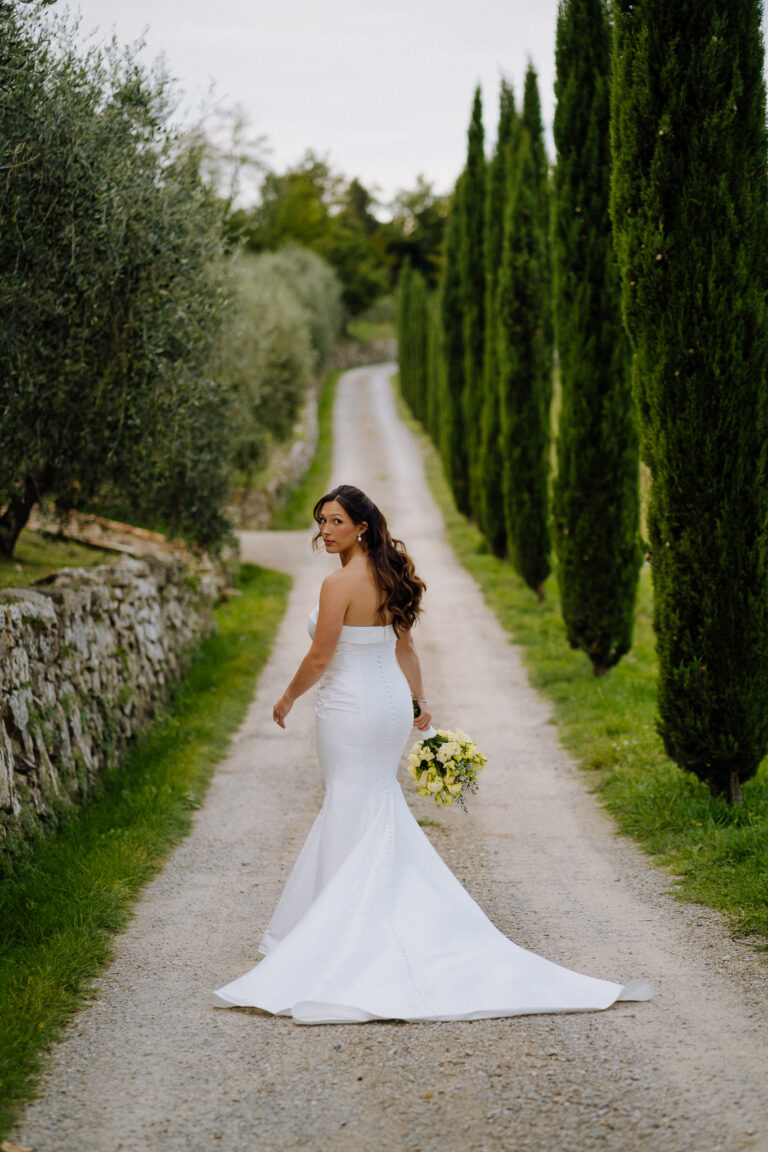 Bride portrait on a cypress-lined path in Tuscany