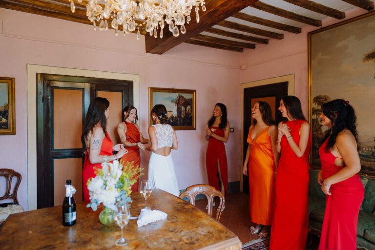 Bridesmaids in orange dresses, getting ready