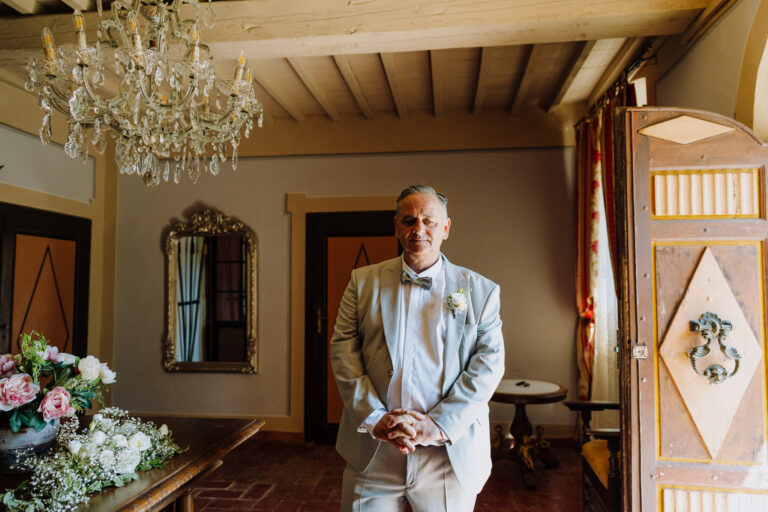 Dad waiting the bride portrait indoors at Villa Cini, Tuscany