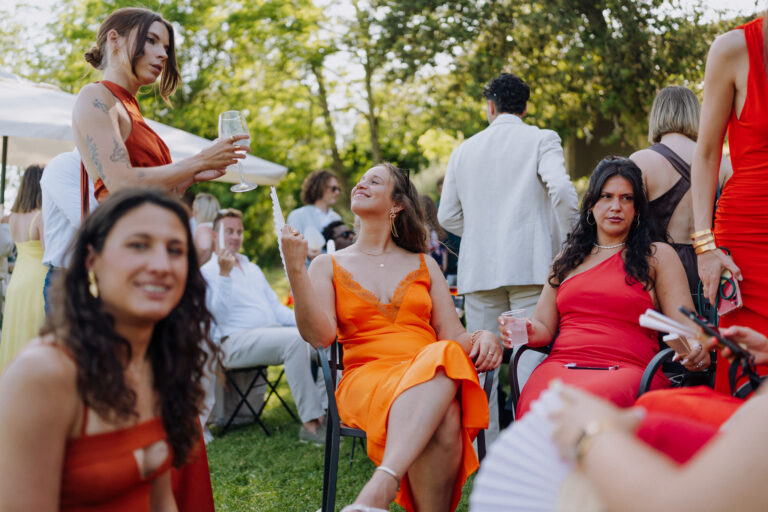 Group of friends seated outdoors, Tuscany