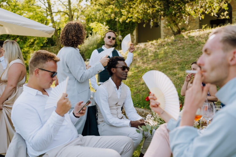 Group of friends seated outdoors, Tuscany