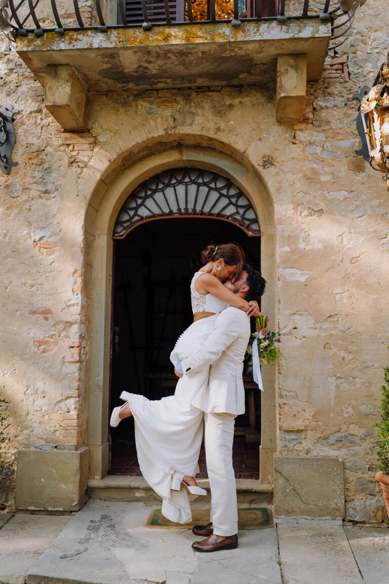 Bride and groom at the villa doorway, Tuscany.