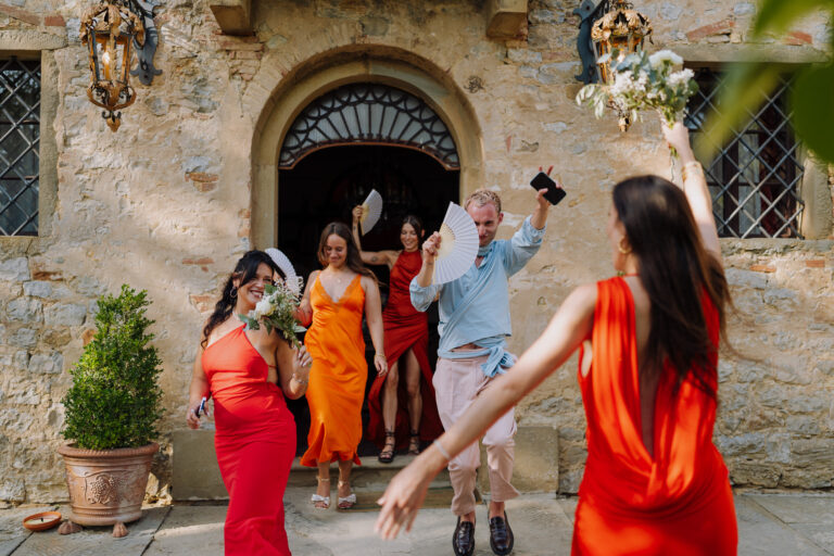 Bridesmaids walking together outside, Tuscany
