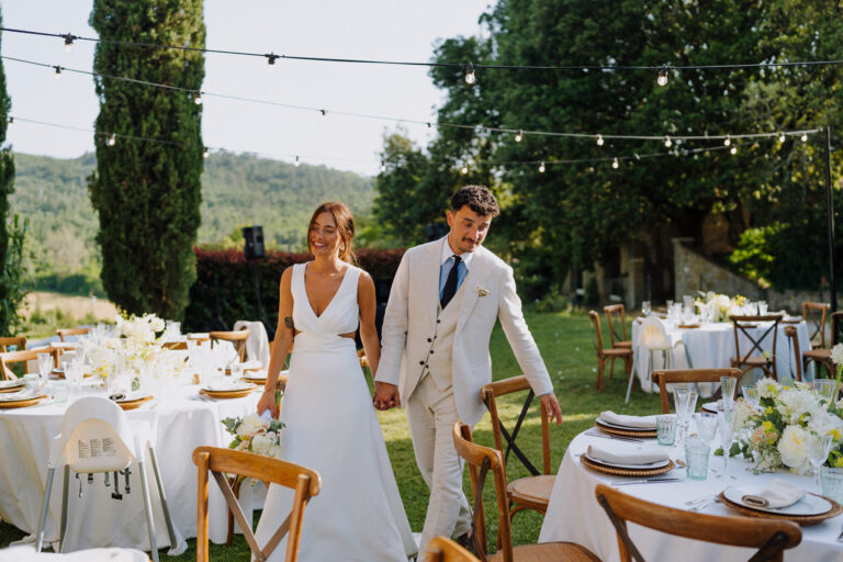 Couple walking past dinner tables, Villa Cini.